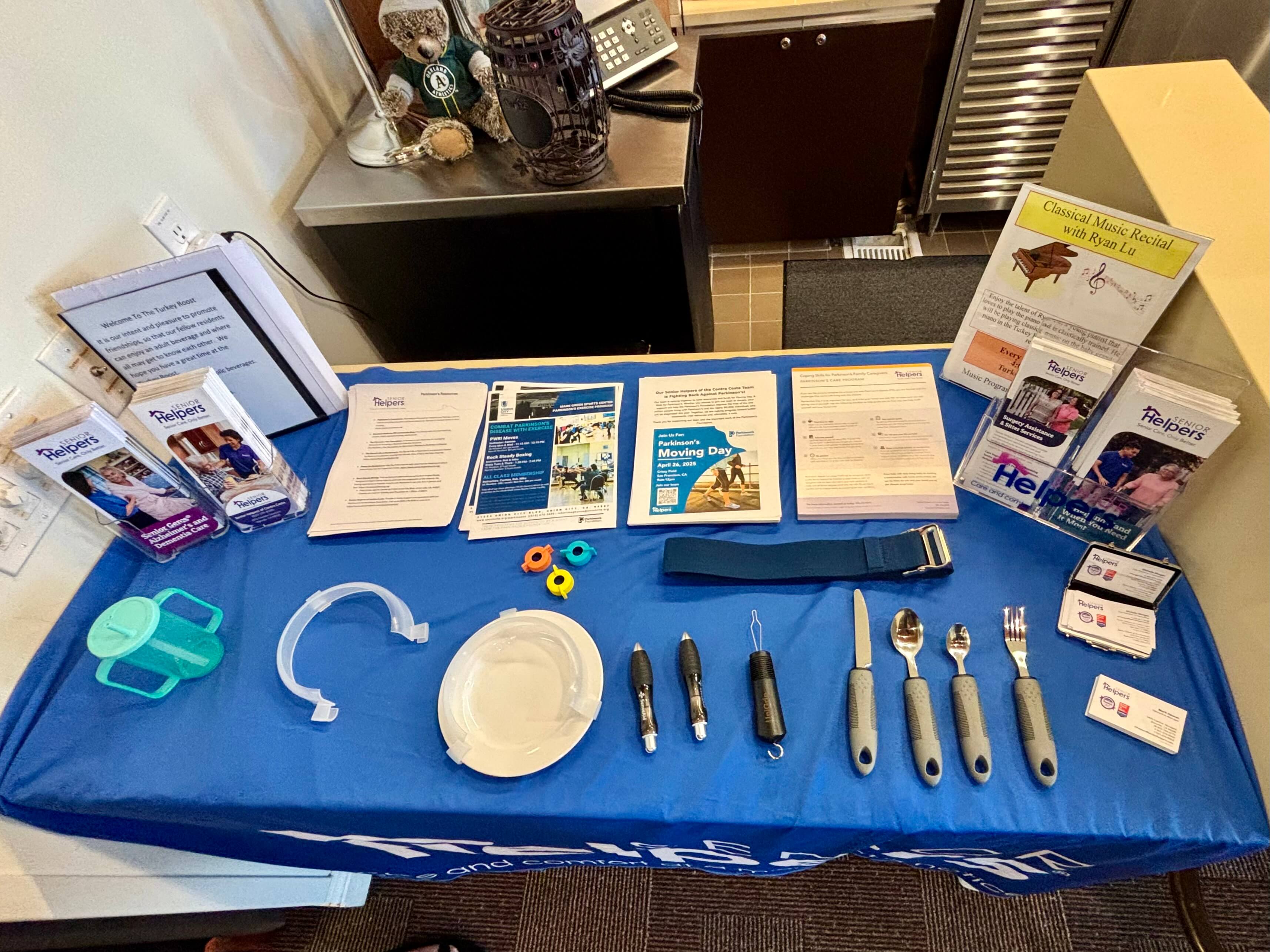 Michelle and Mark also brought various tools that someone with Parkinsons's can use to remain independent for feeding, writing, and drinking (as seen on the table).